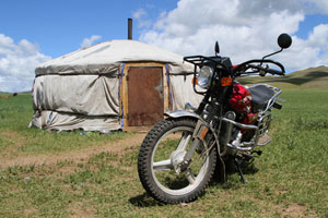 dual-sport dirt bike in front of tent
